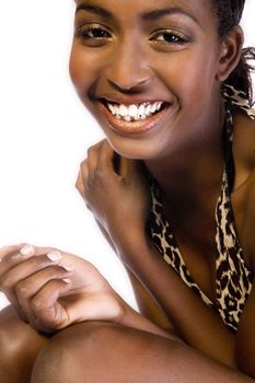 A beauty portrait taken from an african model in the studio showing her big smile