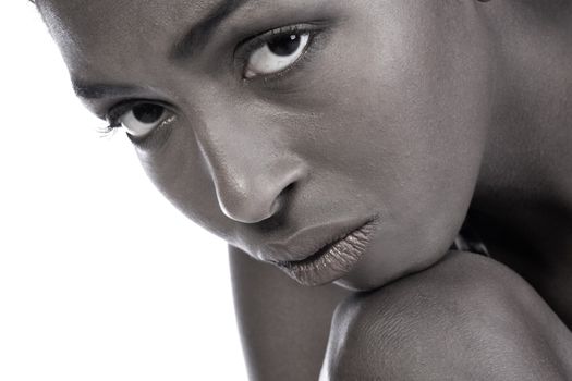 A beauty portrait taken from an african model in the studio looking over from under her eyelids