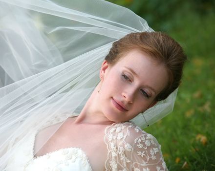 The beautiful bride on a green background