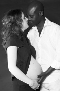 Loving black and white pregnant couple 