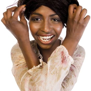 A beauty portrait taken from an african model in the studio fooling with her hair