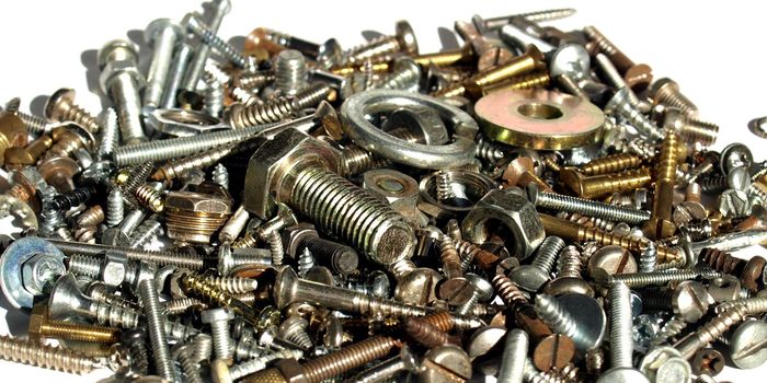 Industrial steel hardware bolts, nuts, screws isolated on white with copyspace