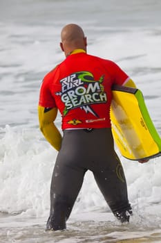 SAN FERNANDO, CADIZ, SPAIN - FEB 19: Unknown bodyboader going to the water on the 2nd championship of Surf and BodyBoard Impoxibol on Feb 19,2011 on the beach of Camposoto of San Fernando, Cadiz, Spain