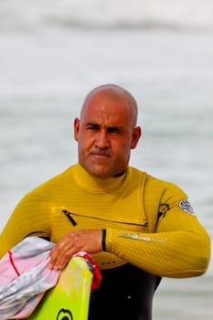 SAN FERNANDO, CADIZ, SPAIN - FEB 19: Unknown bodyboader going to the water on the 2nd championship of Surf and BodyBoard Impoxibol on Feb 19,2011 on the beach of Camposoto of San Fernando, Cadiz, Spain