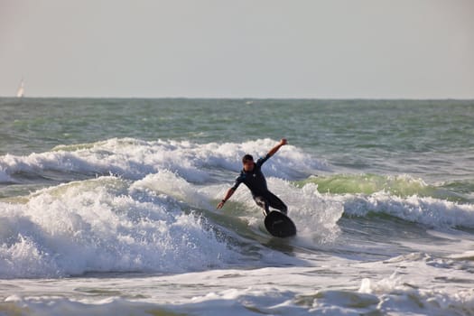 SAN FERNANDO, CADIZ, SPAIN - FEB 19: Unknown surfer taking waves on the 2nd championship of Surf and BodyBoard Impoxibol on Feb 19,2011 on the beach of Camposoto of San Fernando, Cadiz, Spain
