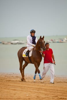 SANLUCAR DE BARRAMEDA, CADIZ, SPAIN - AUGUST 07: Unknown rider at the start of the horses races of the beach of Sanlucar de Barrameda on August 07, 2010 in Sanlucar de Barrameda, Cadiz, Spain.