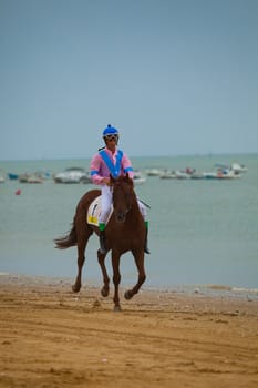 SANLUCAR DE BARRAMEDA, CADIZ, SPAIN - AUGUST 07: Unknown rider at the start of the horses races of the beach of Sanlucar de Barrameda on August 07, 2010 in Sanlucar de Barrameda, Cadiz, Spain.