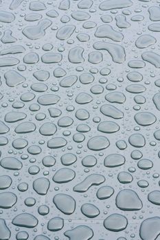 Background of raindrops on a garden table.
