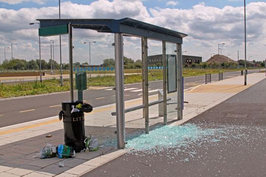 Bus stop vandalised by smashing the glass windows.