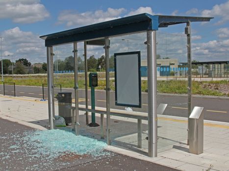 Bus stop vandalised by smashing the glass windows.