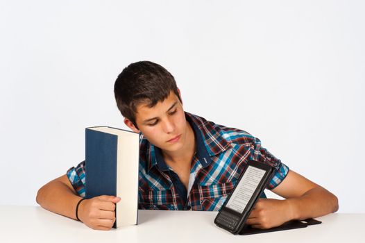Teenager with the traditional and the electronic version of a book