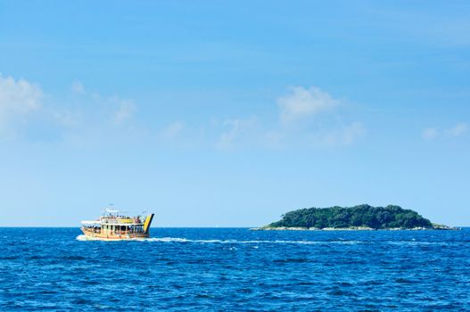 Tourists floating on white boat on the sea of Adriatic