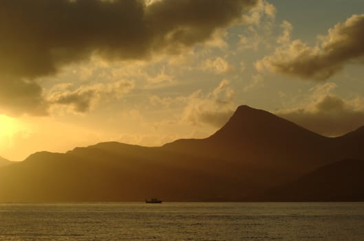 Small boat at the Norwegian Coast at Sunset with Sunrays