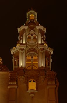 A historical church's steeple at Parque Kennedy in the main tourist district Miraflores (Lima, Peru) photographed at night