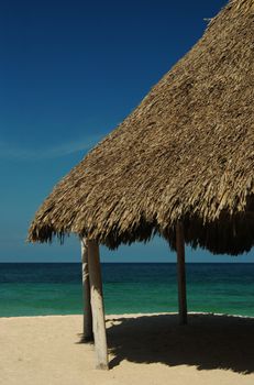 Shadow giving hut at a white sand beach near Cartagena in Colombia