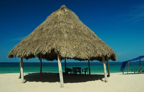 Shadow giving hut at a white sand beach near Cartagena in Colombia