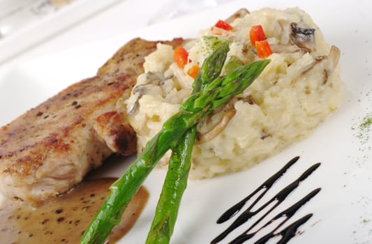 Main dish: Chop with sauce, rice and asparagus (Selective Focus)