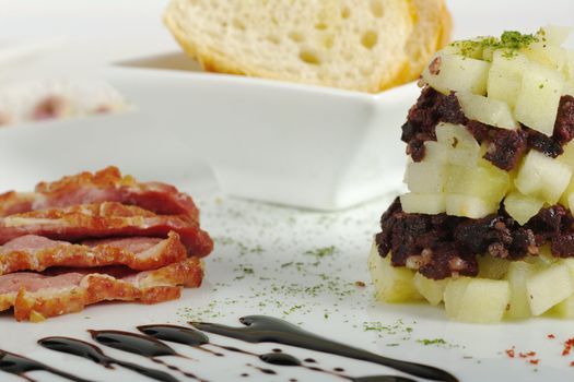 Appetizer: Duck Meat, Blood Sausage, Apples and Baguette on White Plate (Selective Focus) 