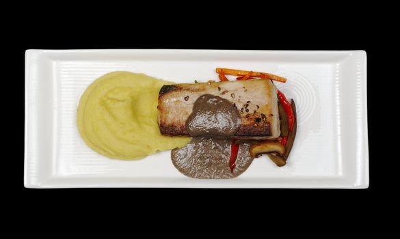 Main Dish: Mediterranean Tuna with mashed potato, gravy and vegetables on white plate and black background, photographed from above