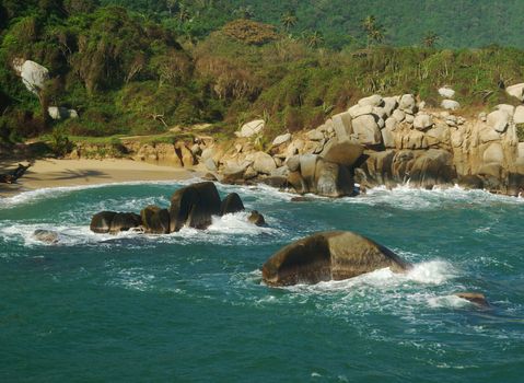 Sandy beach with cliffs in the water on the Caribbean Coast of Colombia (Tayrona National Park, close to Santa Marta)  