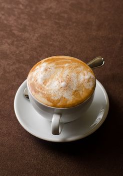 Cappuccino coffee cup closeup at the table