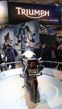 Looking at new motorcycles stands at EICMA, International Motorcycle Exhibition 2010 in Milan, Italy.