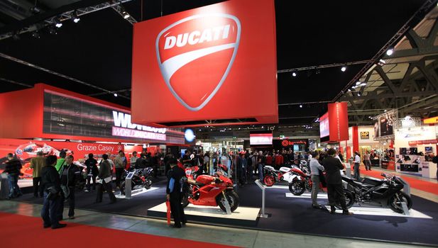 Looking at new motorcycles stands at EICMA, International Motorcycle Exhibition 2010 in Milan, Italy.
