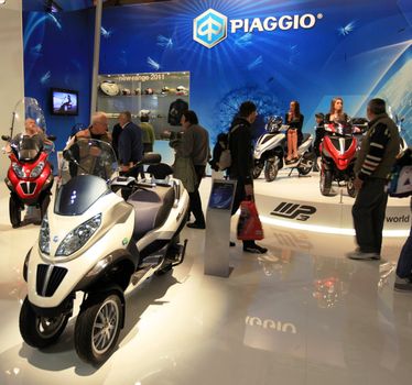 Looking at new motorcycles stands at EICMA, International Motorcycle Exhibition 2010 in Milan, Italy.