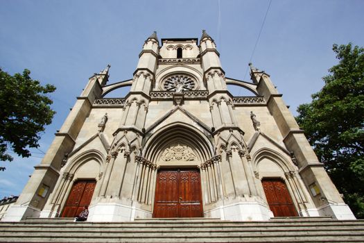 Facade of catholic Notre-Dame basilica place of XXII cantons, Geneva, Switzerland. It was built between 1852 and 1857 by architect Alex Grigny who was inspired by the classical gothic architectural style of XII century and especially Amiens cathedral, France. Last restoration was in 1981.
