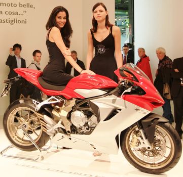 Looking at new motorcycles stands at EICMA, International Motorcycle Exhibition 2010 in Milan, Italy.