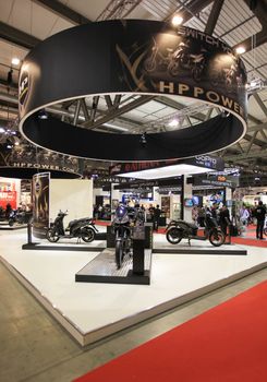 Looking at new motorcycles stands at EICMA, International Motorcycle Exhibition 2010 in Milan, Italy.