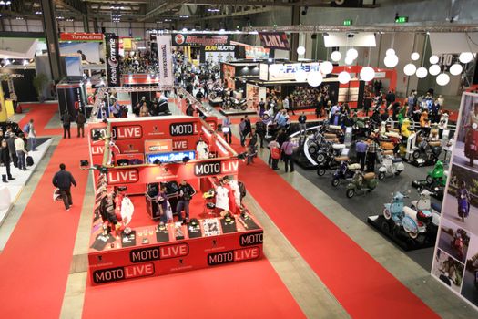 Looking at new motorcycles stands at EICMA, International Motorcycle Exhibition 2010 in Milan, Italy.