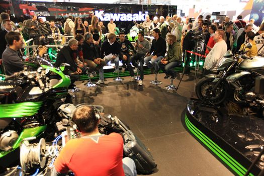 Looking at new motorcycles stands at EICMA, International Motorcycle Exhibition 2010 in Milan, Italy.