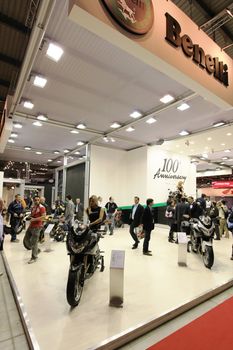 Looking at new motorcycles stands at EICMA, International Motorcycle Exhibition 2010 in Milan, Italy.