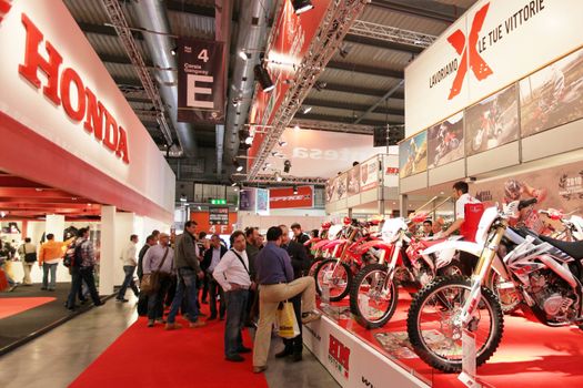 Looking at new motorcycles stands at EICMA, International Motorcycle Exhibition 2010 in Milan, Italy.