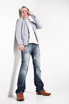 Low angle view at young man speaking on mobile phone