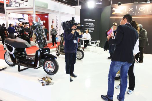 Looking at new motorcycles stands at EICMA, International Motorcycle Exhibition 2010 in Milan, Italy.