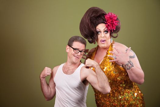 Short muscular man with impressed heavy-set drag queen 