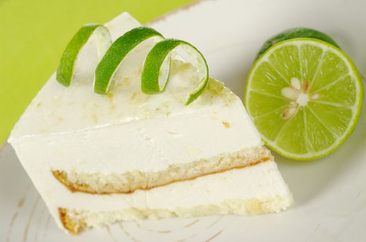 Lime cake with peel of lime on top with lime on a plate (Selective Focus)