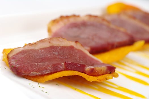 Appetizer: A slice of duck meat on sweet potato chip (Selective Focus)