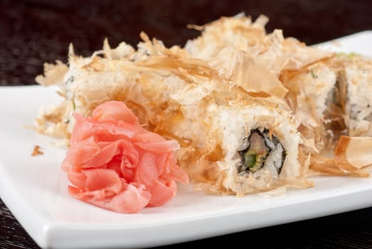 Sushi rolls of rice, nori, cream cheese, avocado, smoked salmon,cucumber and cuts of tuna