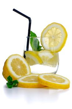 Glass of fresh cool drink with lime fruits isolated on white background.