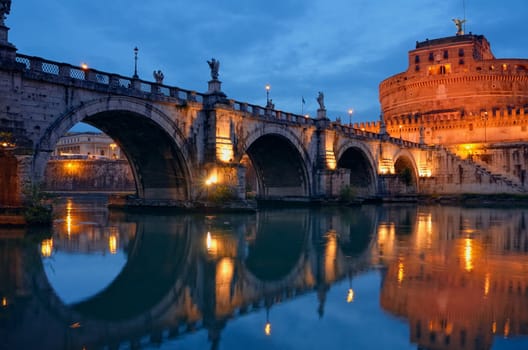 Bridge crossing the river Tiber and Castel Sant'Angelo illuminated at night