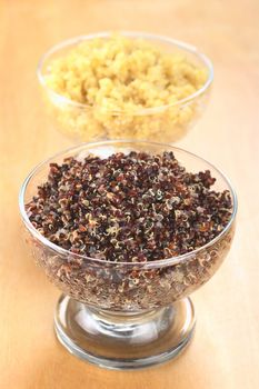 Cooked red and white quinoa in glass bowls which can be eaten as a side dish like rice and is rich in proteins (Selective Focus, Focus on the red quinoa) 