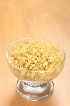 Cooked white quinoa in glass bowl which can be eaten as a side dish like rice and is rich in proteins (Selective Focus, Focus on the front of the quinoa) 