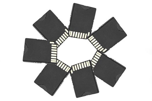 Close up on a circle of black SD memory cards arranged over white
