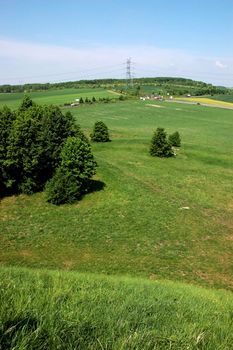 Silesia landscape near Tarnowskie Gory town, Poland. Natural meadows and hills covered with green grass and trees. 