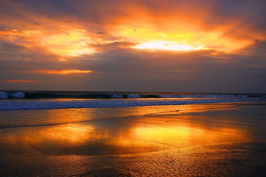 Sunset reflected in the sea, Seminyak beach, Bali