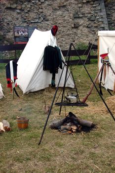 Soldiers camp in Srebrna Gora fortress. Tents, fire place and weapon.