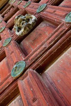 Detail of an ornate door knocker on the door of a building